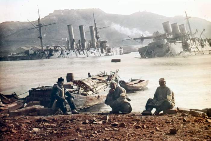 Port Arthur'daki Rus savaş gemisi enkazının yanında üç Japon askeri.