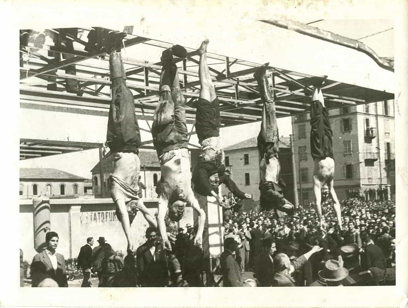 Mussolini'nin (soldan ikinci) cesedi, Petacci (ortada) ve diğer idam edilen faşistlerin yanında, Piazzale Loreto, Milano, 1945.